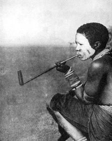 A South African tribesman smoking, 1936.Artist: South African Railways