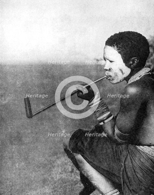 A South African tribesman smoking, 1936.Artist: South African Railways