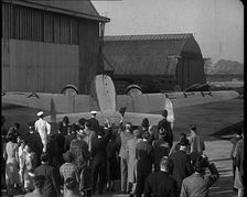 A Small Crowd at Heston Aerodrome Cheering the Moving Lockheed Aeroplane Carrying the..., 1938. Creator: British Pathe Ltd