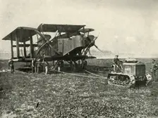 A Small Motor Tractor Getting a Huge R.A.F. Bombing Machine into Position... (1919). Creator: Unknown