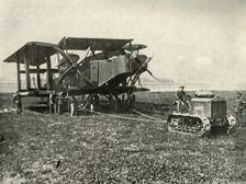 A Small Motor Tractor Getting a Huge R.A.F. Bombing Machine into Position... (1919). Creator: Unknown