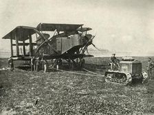 A Small Motor Tractor Getting a Huge R.A.F. Bombing Machine into Position... (1919). Creator: Unknown