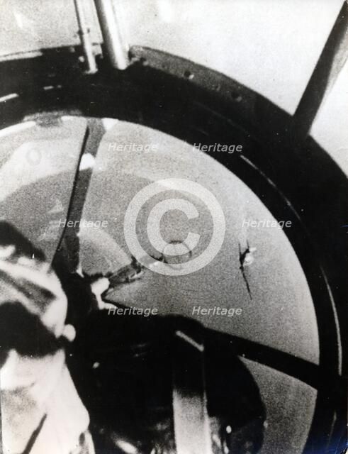 A Spitfire seen from a HE 111K, after diving through the German bomber formation. Artist: Unknown