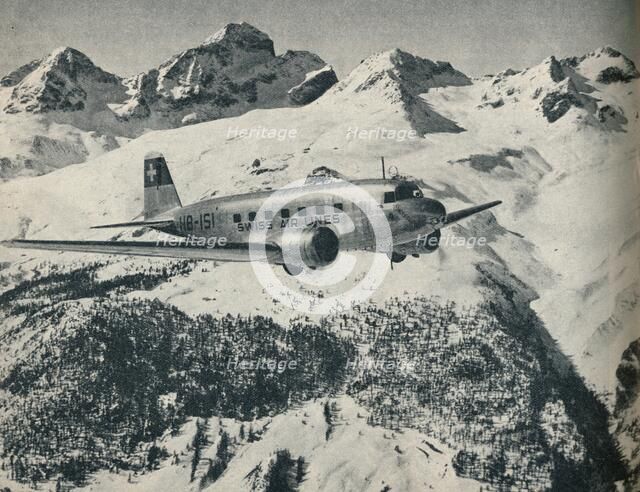 A Swissair plane flying near St Moritz Aerodrome, Switzerland, c1936 (c1937). Artist: Unknown.