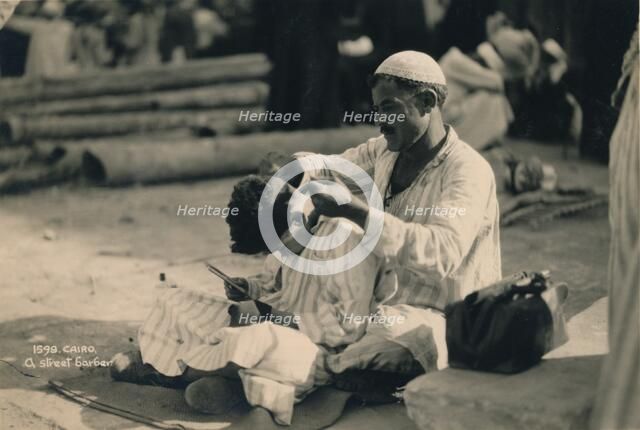 A Street Barber, Cairo, Egypt, 1936. Artist: Unknown