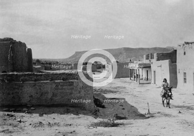 A street scene in San Ildefonso Pueblo, 1905, c1905. Creator: Edward Sheriff Curtis.