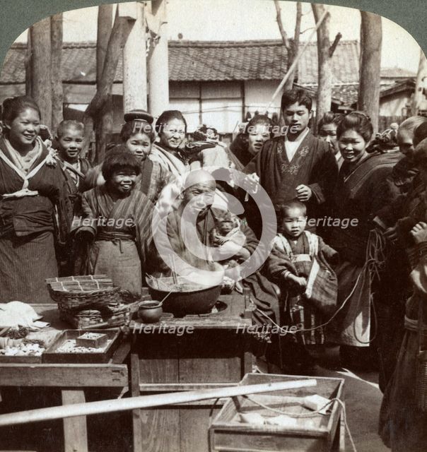 A street performer with a monkey amusing the crowd, Kobe, Japan, 1896.Artist: Underwood & Underwood