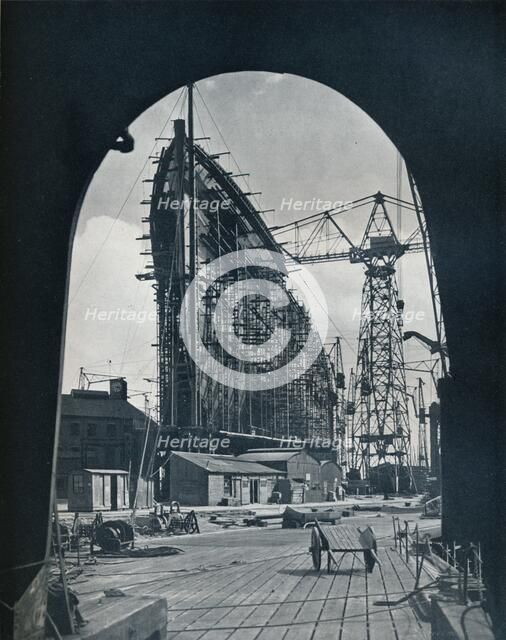 'A striking bow view of the giant Cunard liner, Queen Mary, at Clydebank, Glasgow', 1934. Artist: Unknown.