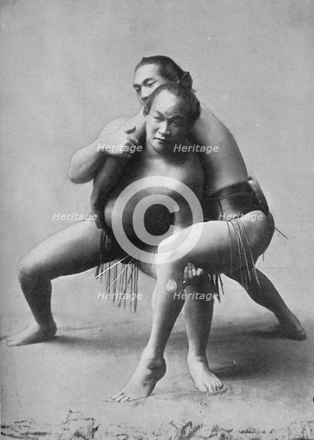 A sumo wrestling bout between a pair of Japanese professionals, 1902. Artist: Unknown.