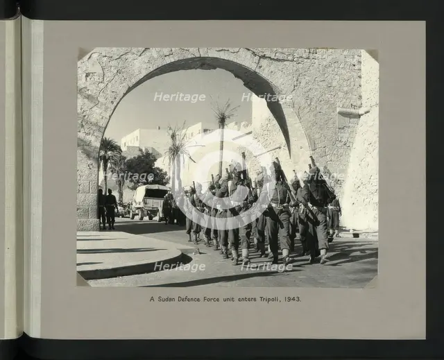 A Sudan Defence Force unit enters Tripoli, 1943. Showing Tripoli Castle on Piazza Italia. Creators: Colonial Office, Unknown.