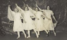 Amateur actors in drag, wearing white dresses and dancing on stage, [between 1910 and 1919?]. Creator: Unknown