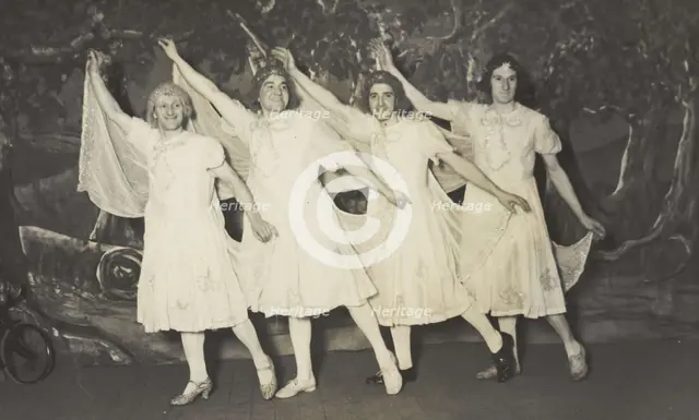 Amateur actors in drag, wearing white dresses and dancing on stage, [between 1910 and 1919?]. Creator: Unknown.