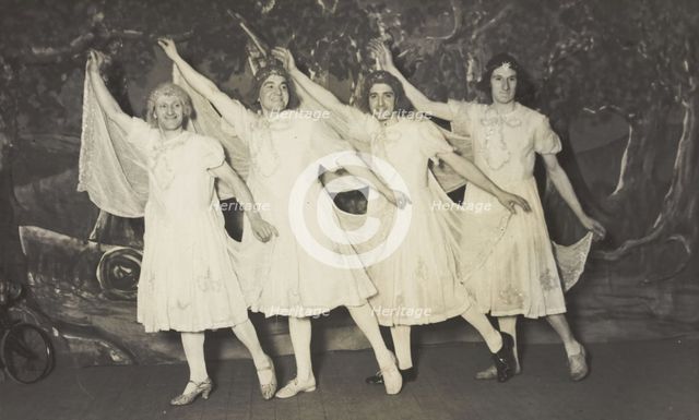 Amateur actors in drag, wearing white dresses and dancing on stage, [between 1910 and 1919?]. Creator: Unknown.