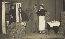 Amateur actors, one in drag, perform a scene on stage, [between 1910 and 1919?]. Creator: Unknown
