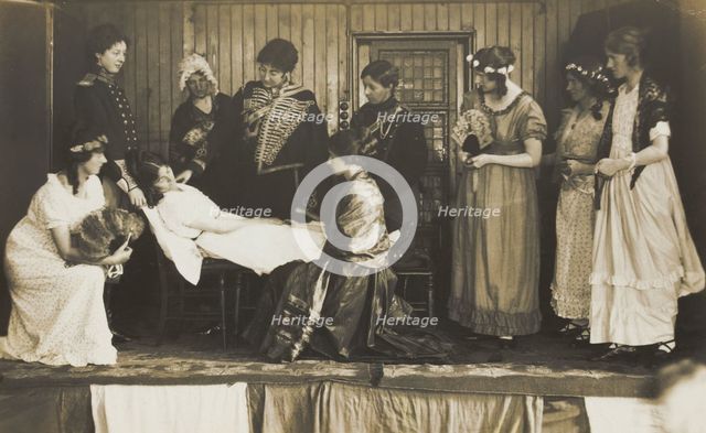 Amateur actors, some in drag, on stage attending to the death of a female character, [1910-1919?]. Creator: Unknown.