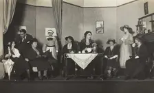 Amateur actors, some in drag, are having tea on stage, [between 1920 and 1929?]. Creator: Unknown