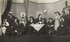 Amateur actors, some in drag, are having tea on stage, [between 1920 and 1929?]. Creator: Unknown