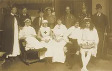 Amateur actors, some in drag, pose for a group portrait, (between 1910 and 1919?). Creator: Unknown