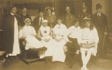 Amateur actors, some in drag, pose for a group portrait, (between 1910 and 1919?). Creator: Unknown