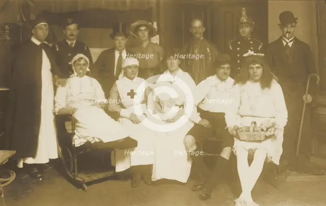 Amateur actors, some in drag, pose for a group portrait, (between 1910 and 1919?). Creator: Unknown.