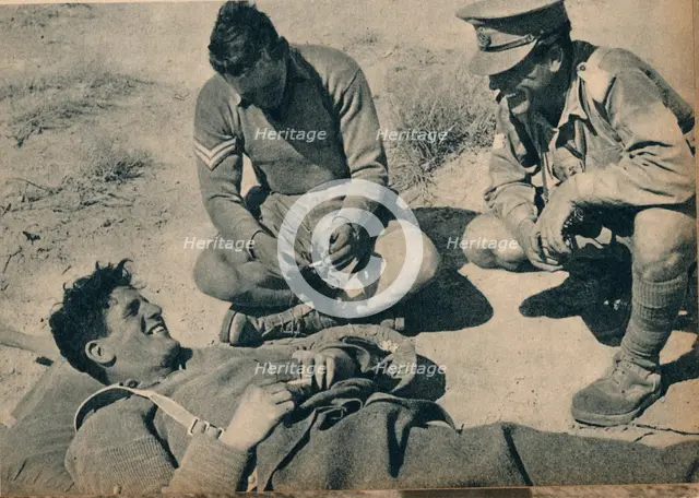 'Ambulance men with a wounded anti-tank gunner', c1942 (1944). Artist: Unknown.