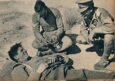 Ambulance men with a wounded anti-tank gunner c1942 (1944)