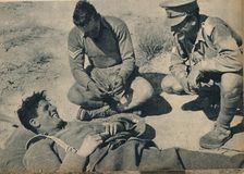 Ambulance men with a wounded anti-tank gunner c1942 (1944)