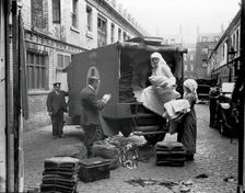 Ambulance Column depot, 9 Gower Street, London: loading up the blanket bus in Gower Mews, 1918. Creator: Unknown