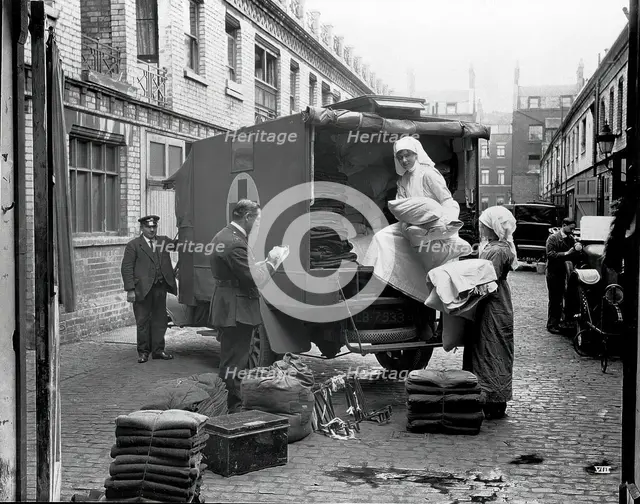Ambulance Column depot, 9 Gower Street, London: loading up the blanket bus in Gower Mews, 1918. Creator: Unknown.