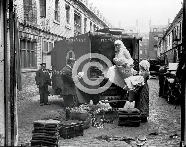 Ambulance Column depot, 9 Gower Street, London: loading up the blanket bus in Gower Mews, 1918. Creator: Unknown.