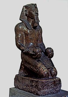 Amenhotep II offering two glasses of wine to a god, statue made in red granite