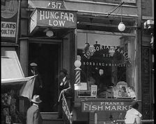 American Civilians Outside a Bobbing and Manicure Parlour, 1930s. Creator: British Pathe Ltd