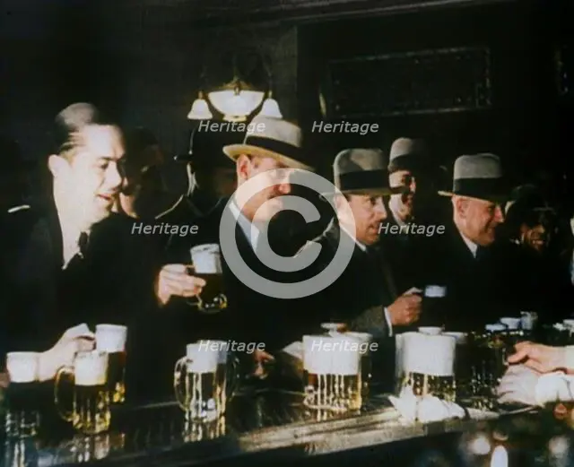 American Civilians Celebrating the End of Prohibition Drinking in a Bar, 1930s. Creator: British Pathe Ltd.