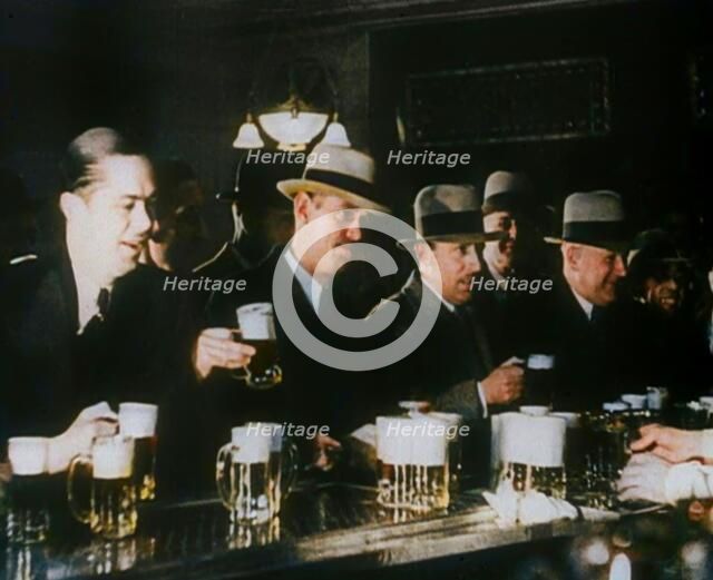 American Civilians Celebrating the End of Prohibition Drinking in a Bar, 1930s. Creator: British Pathe Ltd.