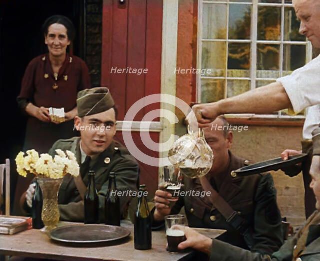 American Airmen Drinking Outside a Public House in England, and Being Served by..., 1943-1944. Creator: British Pathe Ltd.