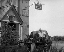 American Airmen Drinking Outside a Public House in England, and Being Served by the..., 1943-1944. Creator: British Pathe Ltd