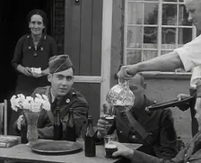 American Airmen Drinking Outside a Public House in England, and Being Served by..., 1943-1944. Creator: British Pathe Ltd