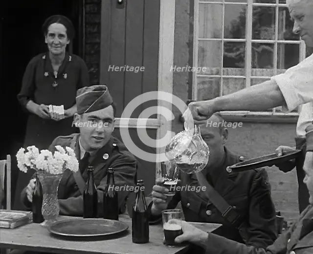 American Airmen Drinking Outside a Public House in England, and Being Served by..., 1943-1944. Creator: British Pathe Ltd.