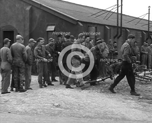 American Airmen Queueing up Outside a Building at an Airfield in England, 1943-1944. Creator: British Pathe Ltd.
