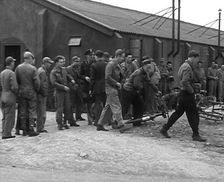American Airmen Queueing up Outside a Building at an Airfield in England, 1943-1944. Creator: British Pathe Ltd