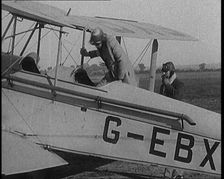 American Aviator Amelia Mary Earhart Wearing a Helmet Boarding an Airplane, 1920. Creator: British Pathe Ltd