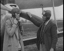 American Aviator Amelia Mary Earhart Wearing a Helmet in Front of an Airplane, 1920. Creator: British Pathe Ltd