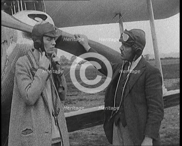 American Aviator Amelia Mary Earhart Wearing a Helmet in Front of an Airplane, 1920. Creator: British Pathe Ltd.