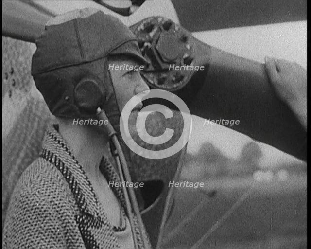 American Aviator Amelia Mary Earhart Wearing a Helmet in Front of an Airplane, 1920. Creator: British Pathe Ltd.