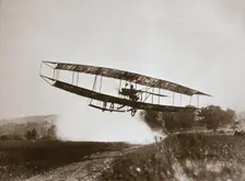 American aviator Glenn Curtiss making the first heavier-than-air flight in his June Bug 1908. Creator: Edwin Levick