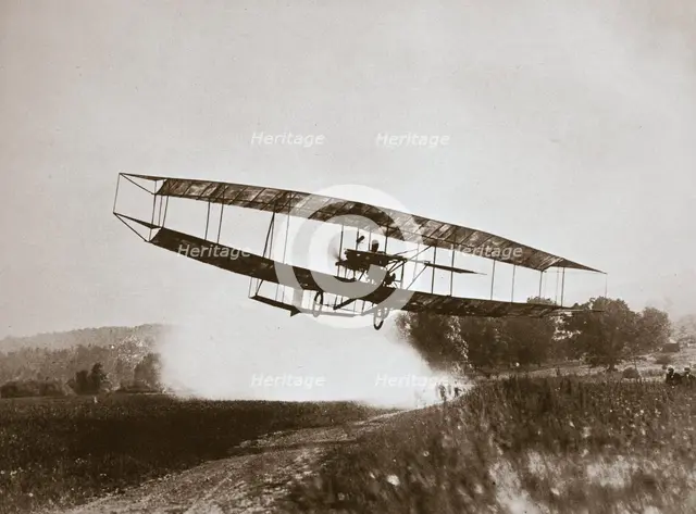American aviator Glenn Curtiss making the first heavier-than-air flight in his 'June Bug', 1908. Creator: Edwin Levick.