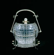 American glass biscuit barrel cut in the shape of a mesh patterned golf ball, 1910