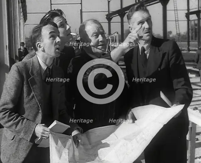 American Engineers Going Over Construction Plans of a Hangar at an Airfield in England, 1943-1944. Creator: British Pathe Ltd.