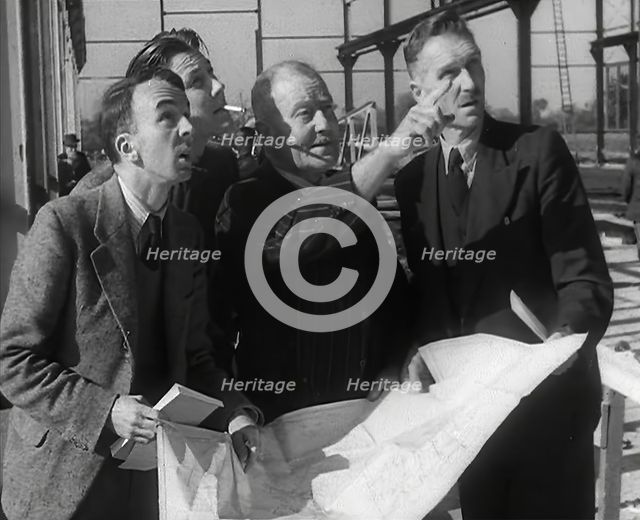 American Engineers Going Over Construction Plans of a Hangar at an Airfield in England, 1943-1944. Creator: British Pathe Ltd.