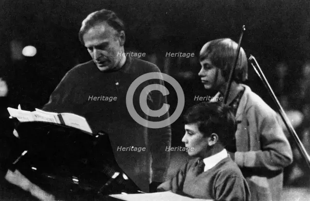 American musician Yehudi Menuhin (1916-1999) instructing his son Jeremy. Creator: Unknown.